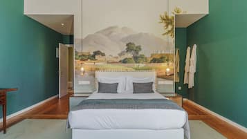 A bedroom with a large bed, a mural on the wall, and a view of mountains.