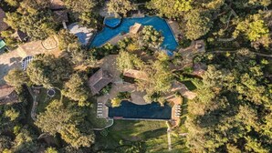 An aerial view of a residential area with a swimming pool, tennis court, and surrounding greenery. - Club Mahindra Resort - Tungi, Lonavala, Maharashtra (Mawal)