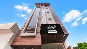 A tall building with a modern design, featuring a prominent 'Collection' sign and a company-serviced label. - Collection O Banaras Railway Station (Varanasi)