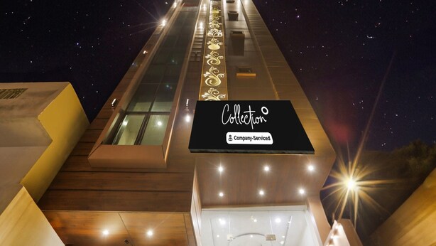 A modern hotel entrance with a sign reading "Collection Company-Serviced". - Collection O Banaras Railway Station (Varanasi)