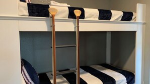 A bunk bed with a ladder, pillows, and a striped blanket. - Relaxing Lago Vista Hill Country Loft w/ Free Parking & Deer Sightings (Lago Vista)