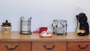 A wooden dresser with drawers and a table in front.