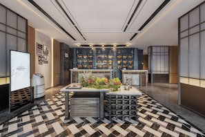 A modern hotel lobby with a check-in counter, a reception desk, and a display board. - Four Points by Sheraton Harbin City Center (Harbin)