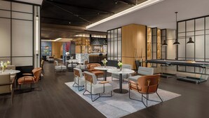A modern lounge area with round tables, leather chairs, a pool table, and a bar area with shelves of bottles. - Four Points by Sheraton Qingtian (Lishui)