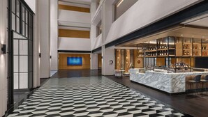 A hotel lobby with a checkered floor, a reception desk, a bar area, and a large screen TV. - Four Points by Sheraton Qingtian (Lishui)