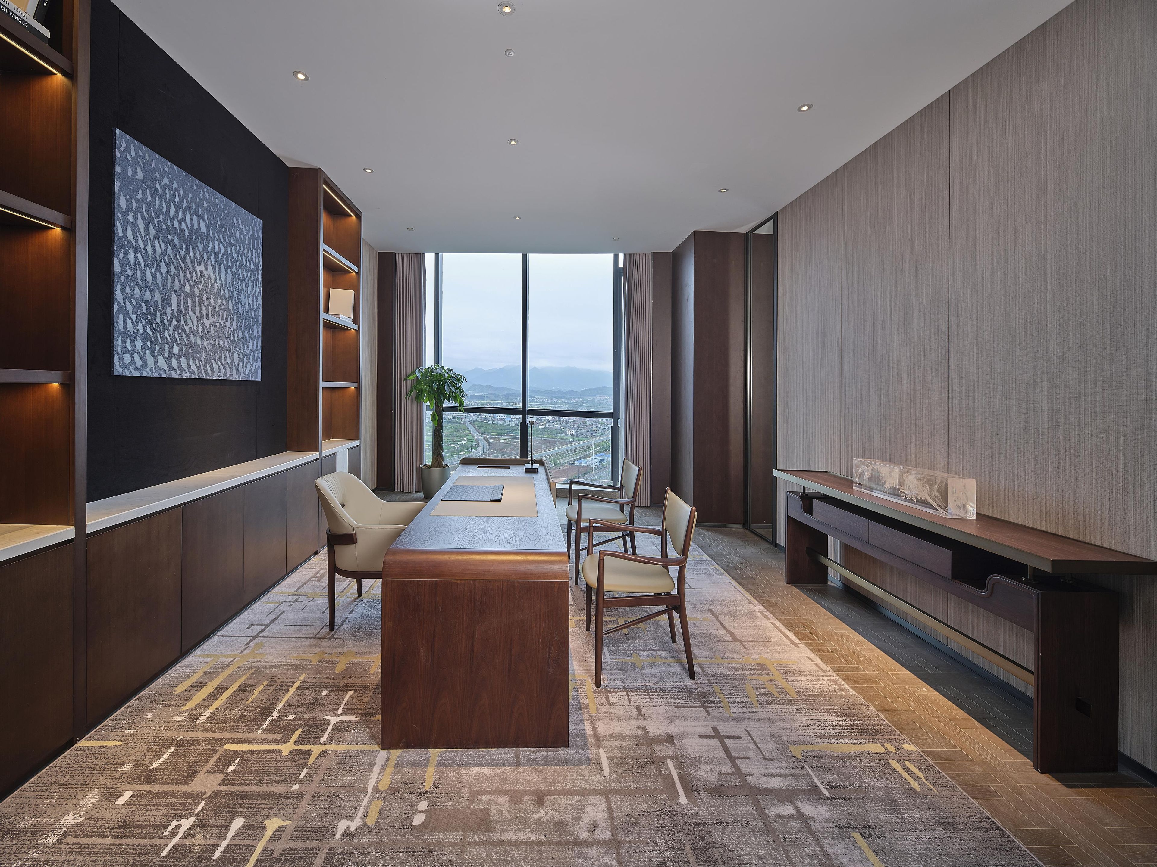 Une salle de conférence moderne, dotée d’une grande table, de chaises et offrant une vue sur le paysage urbain grâce à de larges fenêtres.