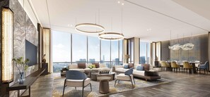 A modern living room with a city view, large windows, and contemporary furniture. - Hilton Quzhou (Quzhou)