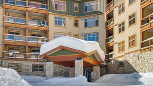 A multi-story hotel with a stone facade and wooden balconies. - Okanagan - Aspens 4605 (Big White Mountain)