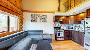 A modern kitchen with wooden cabinets, a built-in oven, and a refrigerator. - Okanagan - Lac Le Jeune at Cabin 4 (Kamloops)