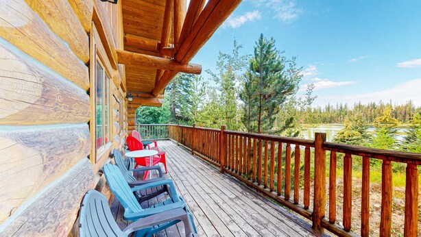 A wooden deck with a view of a forest and a lake. - Okanagan - Lac Le Jeune at Cabin 3 (Kamloops)