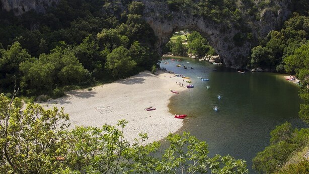 A beach with boats, a clear sky, and a natural rock arch. - Blue Hills Residence with Scenic Views (Sampzon)