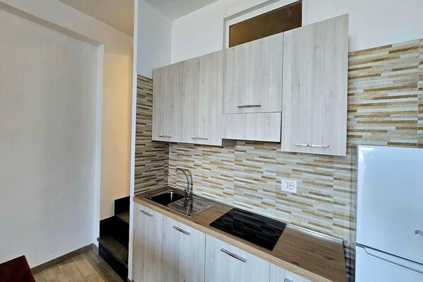 Fridge, stovetop, coffee/tea maker, dining tables