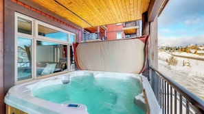 A hot tub on a balcony with a view of a snowy landscape. - Okanagan - Raven 104 (Big White Mountain)
