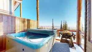 A wooden cabin with a hot tub and a grill on a balcony overlooking a mountainous landscape. - Okanagan - Snowy Creek 10 (Beaverdell)