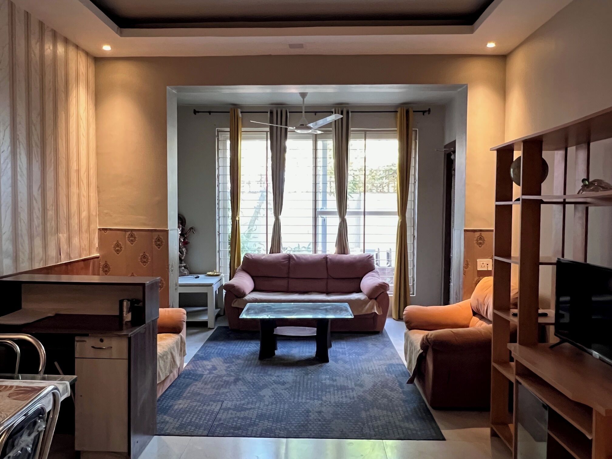 A modern living room with a sofa, a coffee table, and a TV stand.