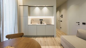 A compact kitchen with integrated cabinets, a sink, and a coffee maker. - Evangelisti Palace (Bellaria-Igea Marina)