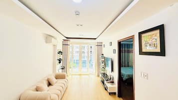 Family Apartment, Balcony, Pool View | Living area | 55-inch Smart TV with digital channels