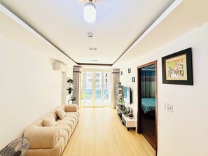 Family Apartment, Balcony, Pool View | Living area | 55-inch Smart TV with digital channels - LaLa Tan Son Nhat Airport Skycenter (Tan Binh)