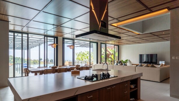 A modern kitchen with a large island, built-in appliances, and a dining area with a view. - Diamond Hill 10 Br Heated Pool (Bandung)