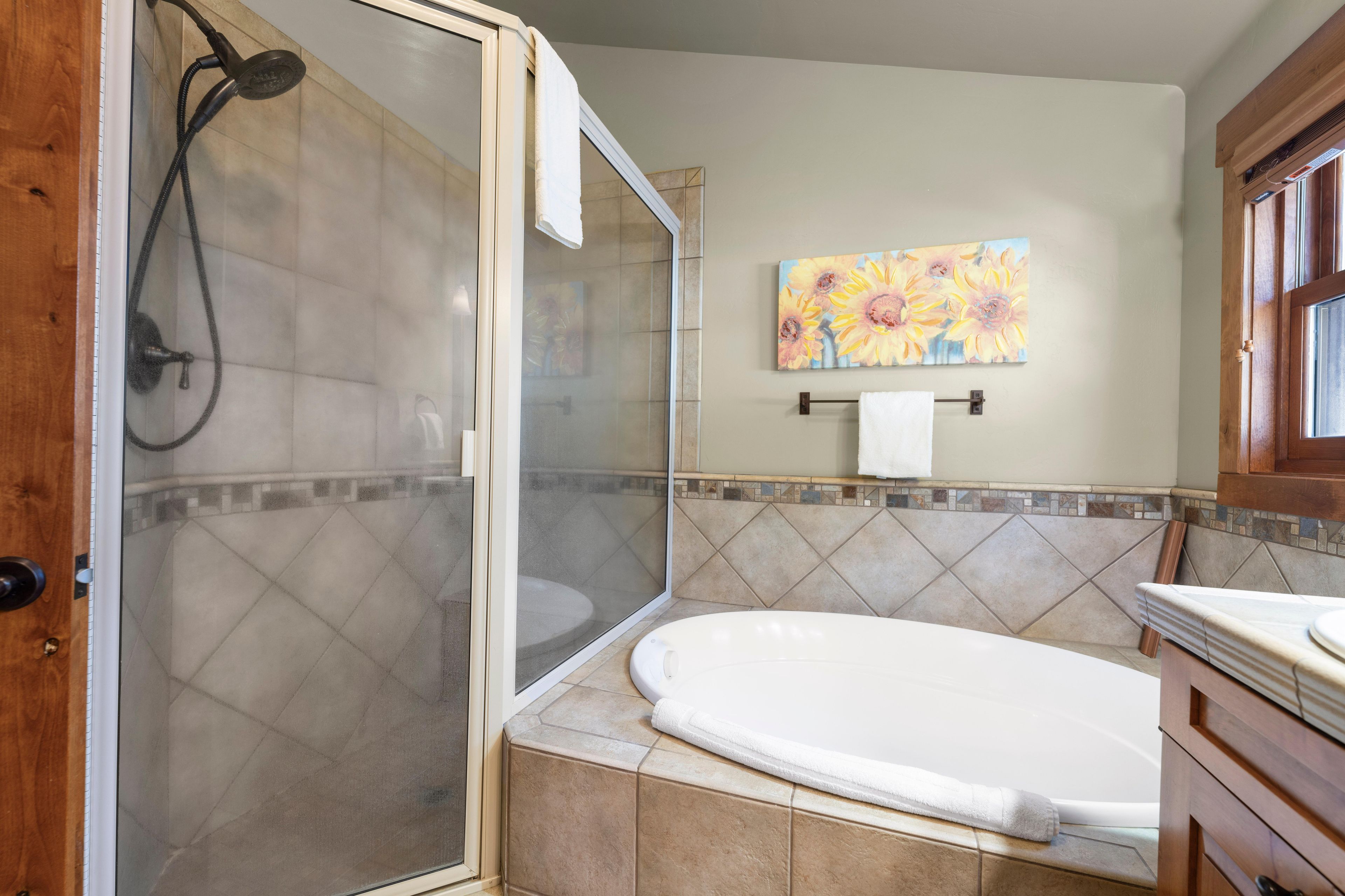 A bathroom with a shower, a bathtub, and a toilet.