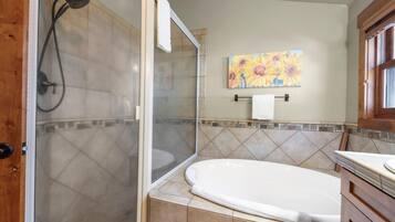 A bathroom with a shower, a bathtub, and a toilet.