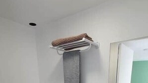 A small bathroom with a toilet, sink, and towel rack. - Pleasant studio Bourgueil center (Bourgueil)