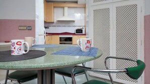 A dining area with a round table, two chairs, and two mugs on a placemat. - DETACHED HOUSE WITH GARDEN, FIVE MINUTES FROM THE BEACH. (Almeria)
