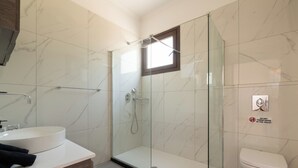 A modern bathroom with a glass-enclosed shower, a white sink, and a toilet. - Anthi Luxury Residence- Jasmine (Ialisos)