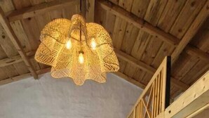 A wooden-framed room with a bed, a hanging light fixture, and a wooden ceiling. - Tatsaaraa Kavan (Ramgarh)