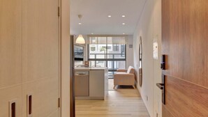 A modern interior with a kitchen area, a dining space, and a seating area with a view of the outside. - w Stylish Radiant Loft in Chapinero (Bogotá)