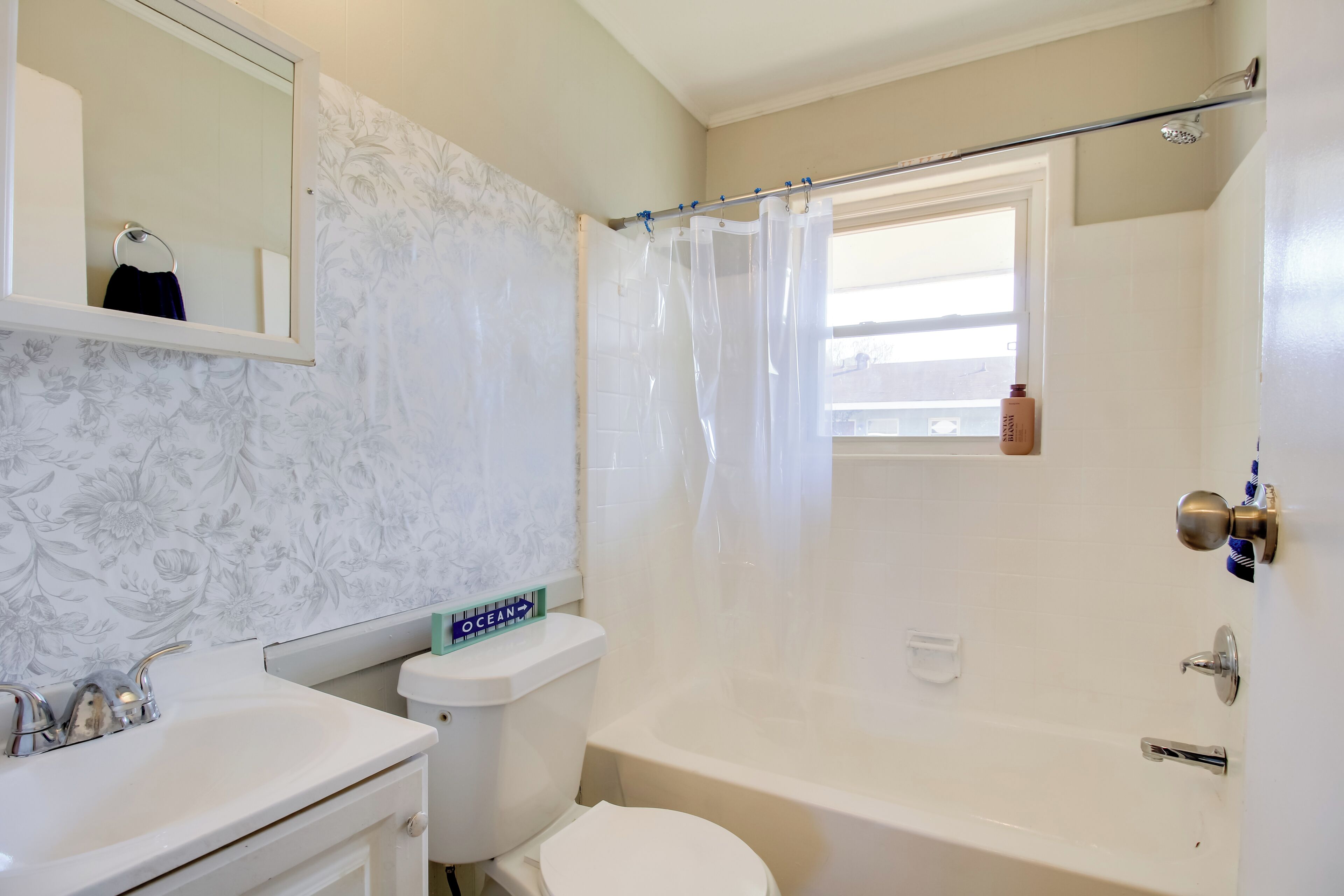 A bathroom with a toilet, sink, and bathtub.