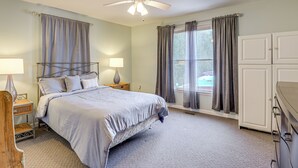 A bedroom with a bed, nightstands, a ceiling fan, a window with curtains, and a wardrobe. - Peaceful Getaway w/ Countryside Views in Upperco (Upperco)