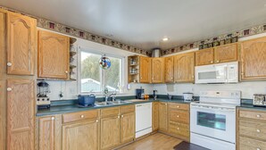 A kitchen with wooden cabinets, a microwave, and a dishwasher. - Peaceful Getaway w/ Countryside Views in Upperco (Upperco)