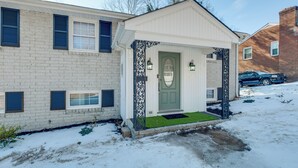 A two-story house with a front porch, a green door, and a brick exterior. - 5 Mi to Fort Gregg-adams: Spacious Family Home (Colonial Heights)