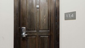 A wooden door with a keypad lock and a sign indicating room number 114. - Whistler - Cascade Lodge 114 (Whistler)
