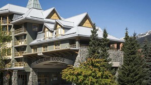 A multi-story building with balconies and a stone facade, labeled "Cascade Lodge." - Whistler - Cascade Lodge 230 (Whistler)