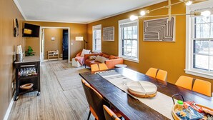 A dining area with a wooden table, orange chairs, and a buffet cart. - Lake Murray Retreat Near USC & Columbia (Columbia)