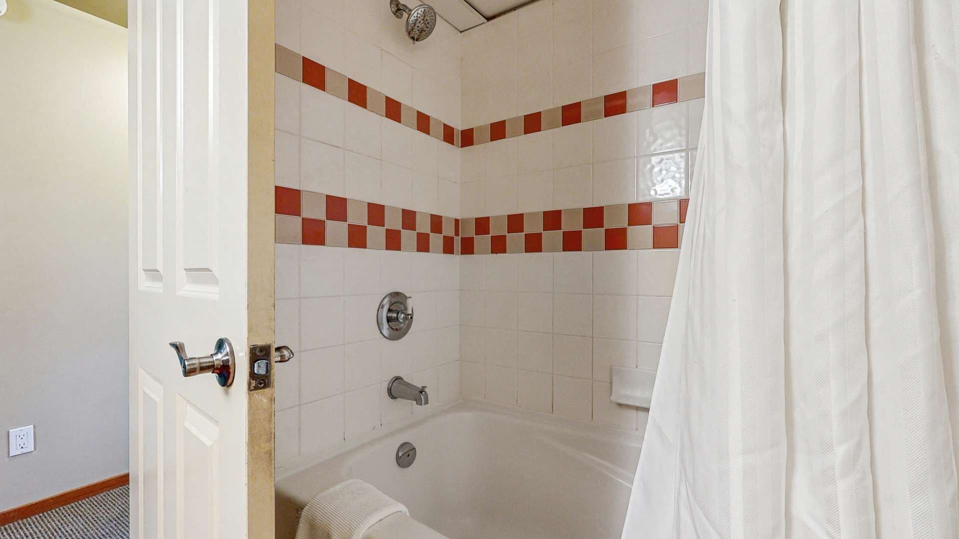 Un baño con bañera, ducha e inodoro.