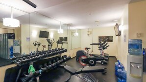 A gym with exercise equipment, a water dispenser, and a mirror. - Whistler - Glacier Lodge 232 (Whistler)