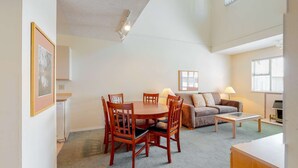 A spacious living room with a dining table, chairs, a sofa, and a coffee table. - Whistler - Glacier Lodge 303 (Whistler)