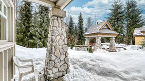 A stone pillar, a covered outdoor area, and snow-covered ground.