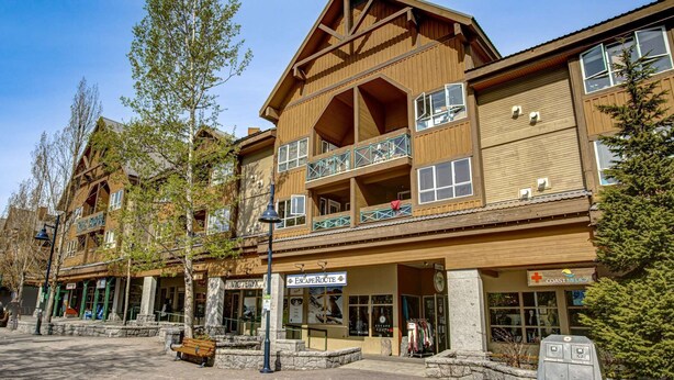 A multi-story wooden building with balconies, a ski shop, and a medical office. - Whistler - Marketplace Lodge 338 (Whistler)