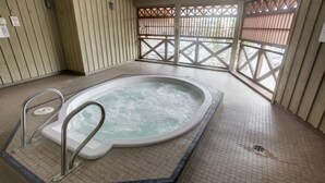 A hot tub in a room with tiled flooring and a wooden wall. - Whistler - Marketplace Lodge 348 (Whistler)
