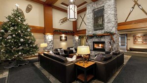 A cozy lobby with a stone fireplace, leather sofas, and a Christmas tree. - Whistler - The Aspens 263 (Whistler)