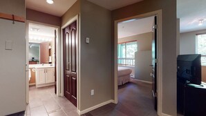 A home interior with a kitchen, a bedroom, and a living area. - Whistler - Town Plaza 302 (Whistler)