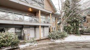 A multi-story building with a fire lane sign, a covered outdoor area, and snow-covered trees. - Whistler - Valhalla #39 (Whistler)