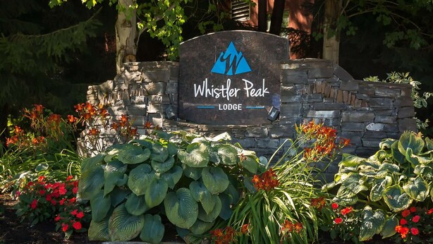 A stone wall with a sign for Whistler Peak Lodge. - Whistler - Whistler Peak Lodge 301 (Whistler)