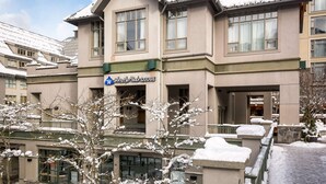 A hotel with a sign reading 'Whistler Peak Lodge,' featuring a symmetrical facade with multiple windows and a central entrance. - Whistler - Whistler Peak Lodge 301 (Whistler)