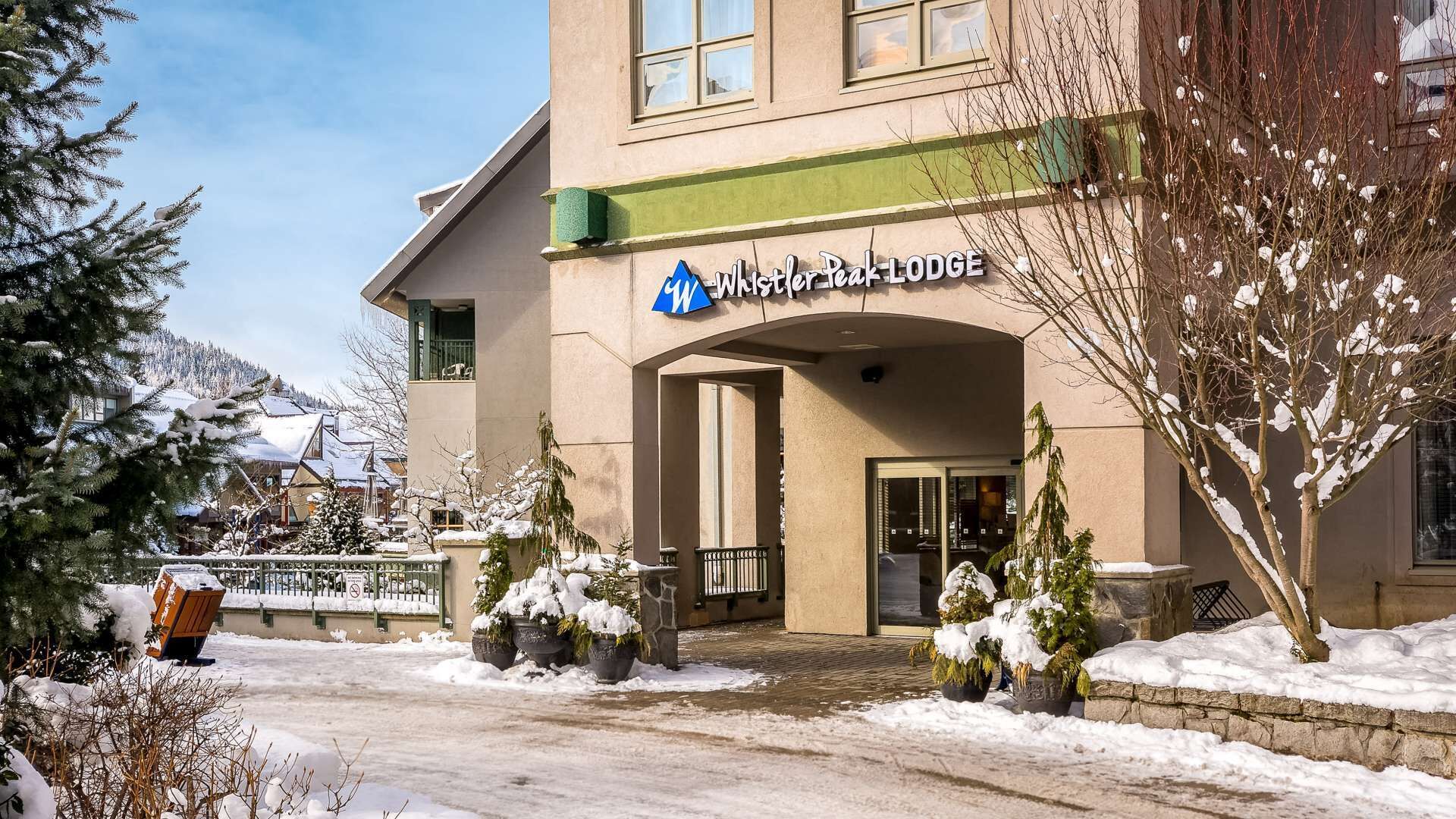 A building with a sign reading 'Whistler Peak Lodge.'