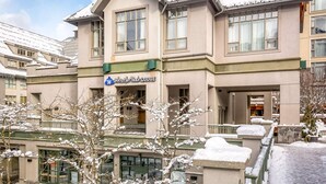A hotel with a sign reading "Whistler Peak Lodge." It has multiple floors with large windows and a snow-covered exterior. - Whistler - Whistler Peak Lodge 418 (Whistler)